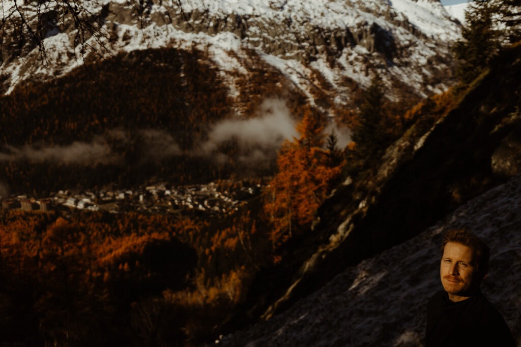 A man standing before a majestic mountain.