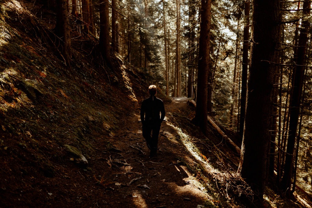 A man hiking through mountainous woods.